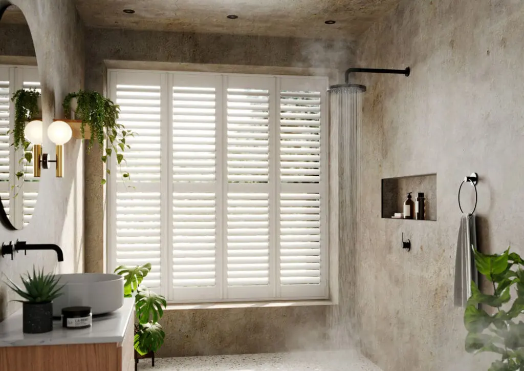 white shutters in neutral stone bathroom with plants