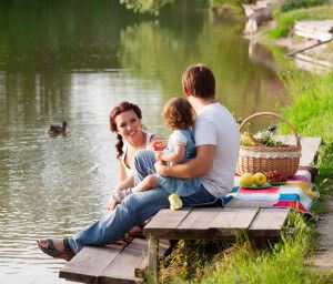 family having picnic by a pond