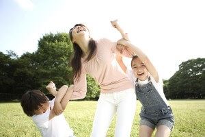 mother and children playing in park