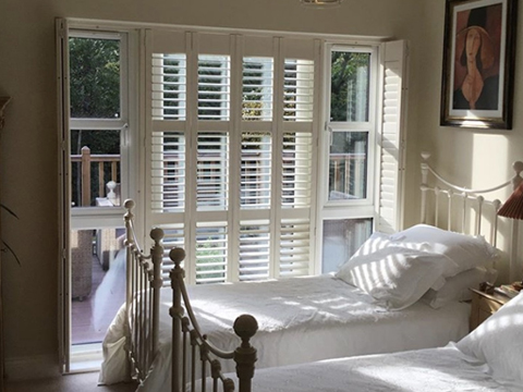 patio door shutters installation in bedroom