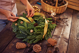 woman making a natural garland wreath