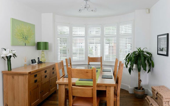 bay window shutter installation in dining room