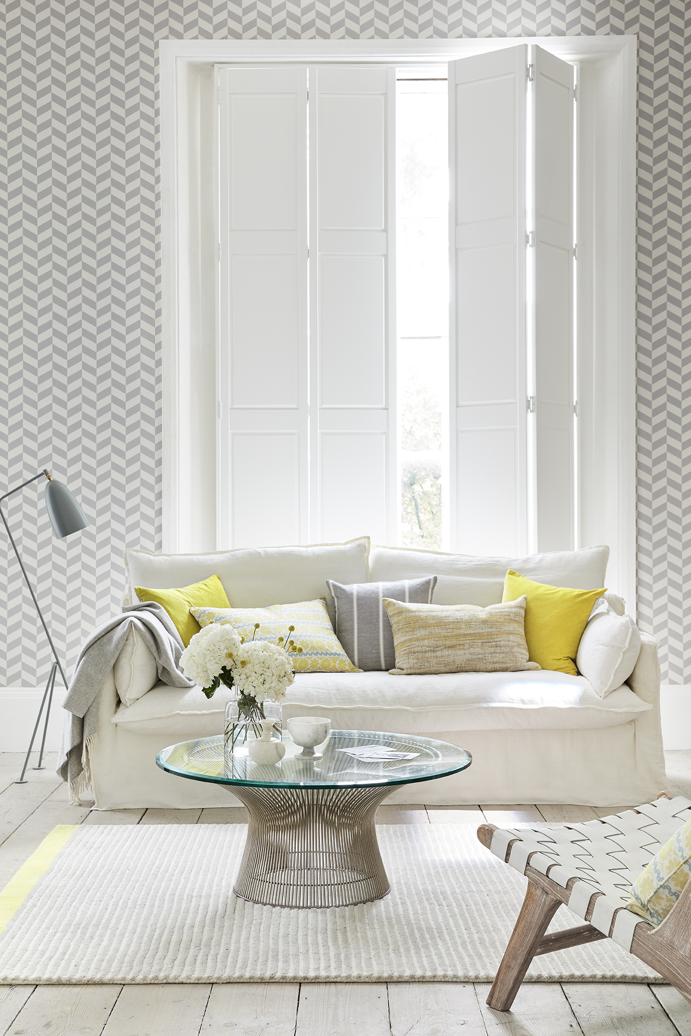 Solid shutters in a modern living room with white and yellow colour tones . 