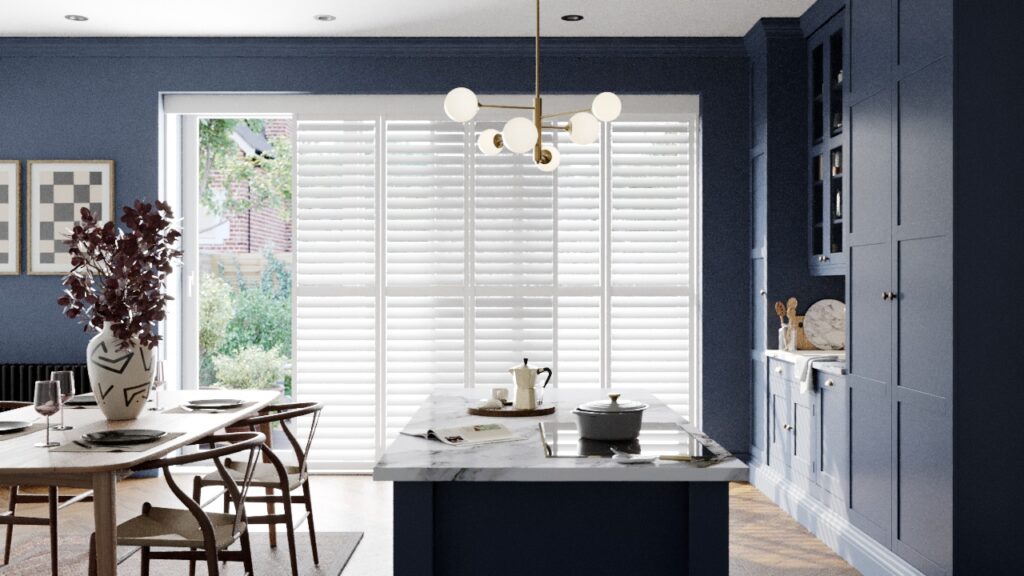 White shutters on patio doors in blue kitchen
