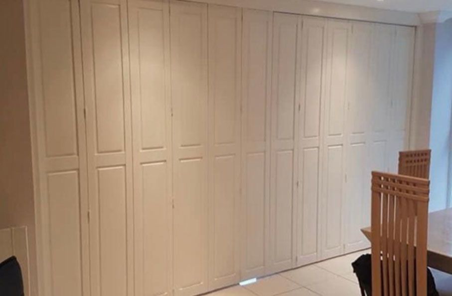Solid full-height window shutters with narrow white panels.