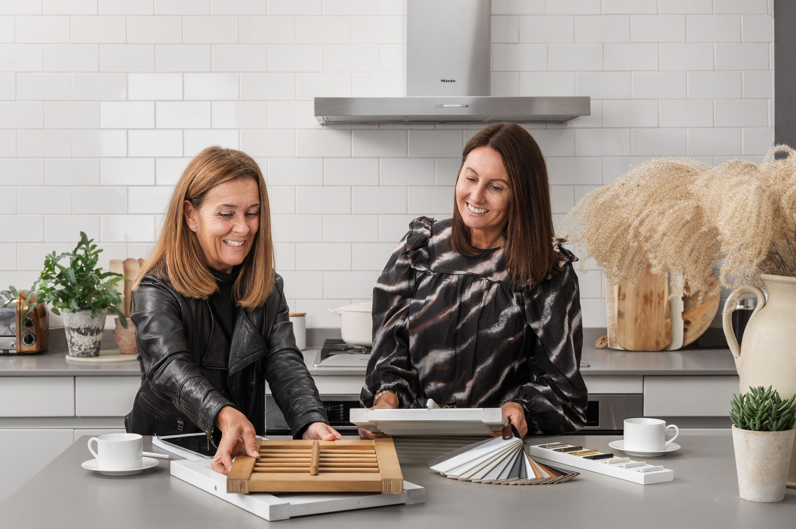 Two women looking at shutter samples 