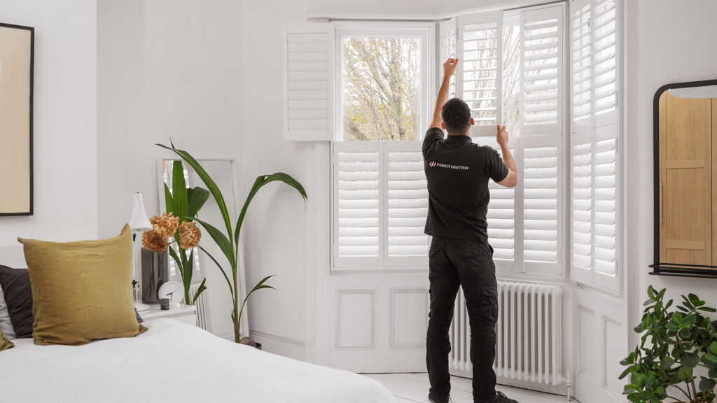 Purely Shutters fitter installing shutters