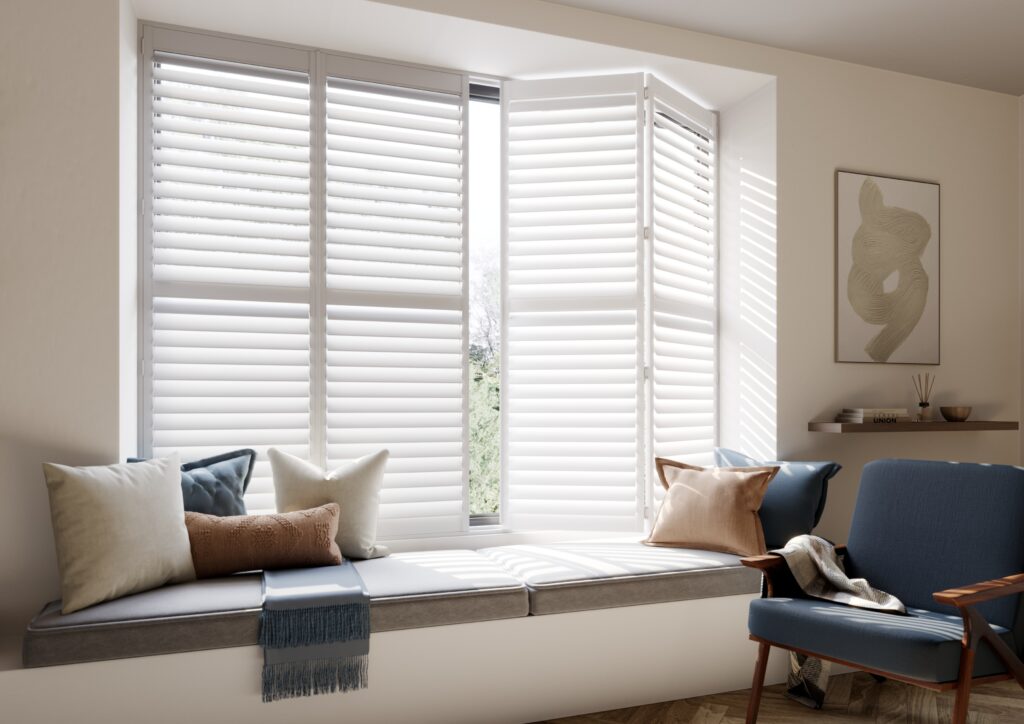 White cafe style window shutters behind seating area